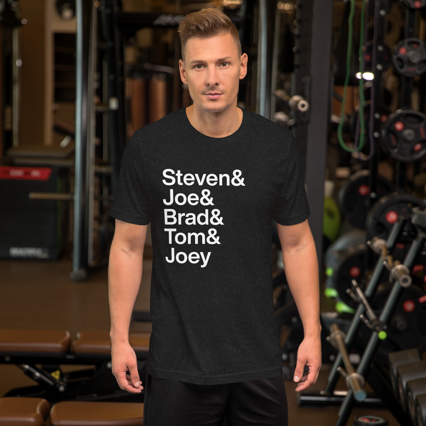 Man at gym wearing black t-shirt with white lettering reading Steven and Joe and Brad and Tom and Joey