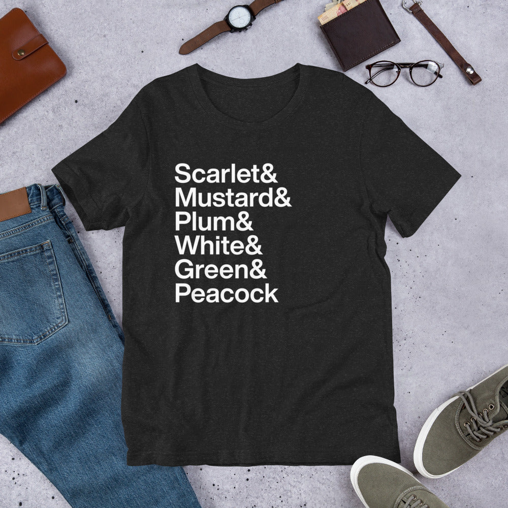 black t-shirt with white lettering depicting the characters from Clue on ground near other apparel