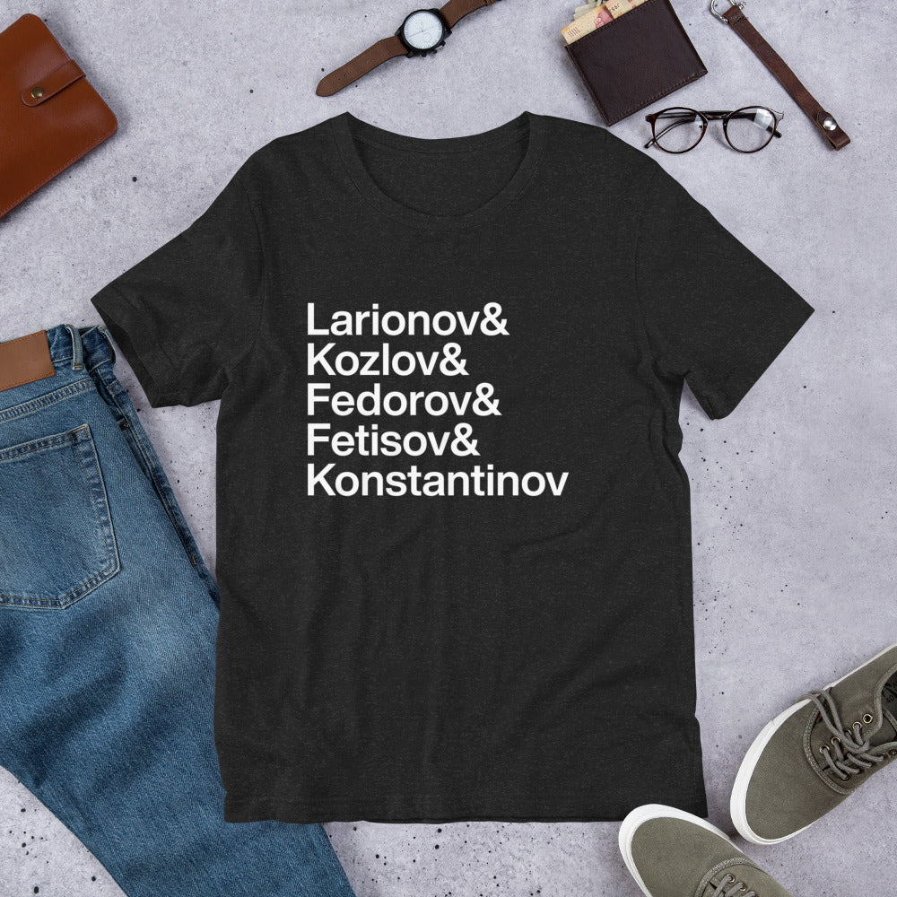 black t-shirt with white lettering reading Larionov and Kozlov and Fedorov and Fetisov and Konstantinov on ground amidst other clothes