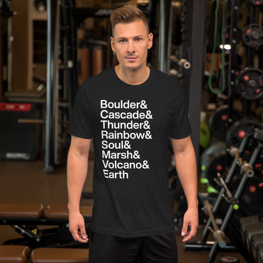 Man at gym in black t-shirt with white lettering reading Boulder and Cascade and Thunder and Rainbow and Soul and Marsh and Volcano and Earth