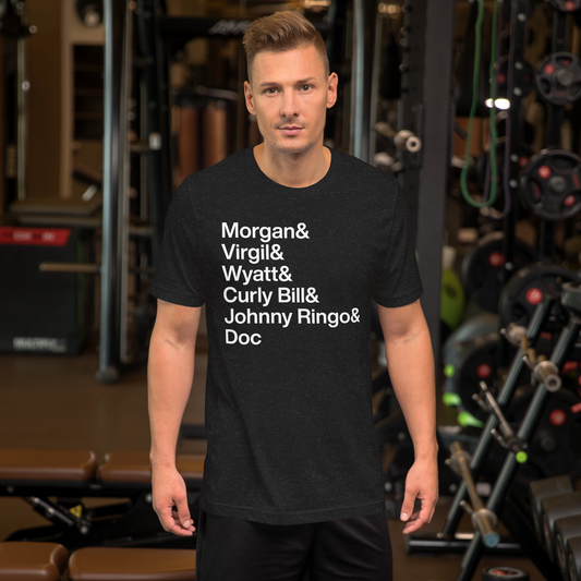 Guy at the gym wearing black t-shirt with white lettering reading Morgan and Virgil and Wyatt and Curly Bill and Johnny Ringo and Doc
