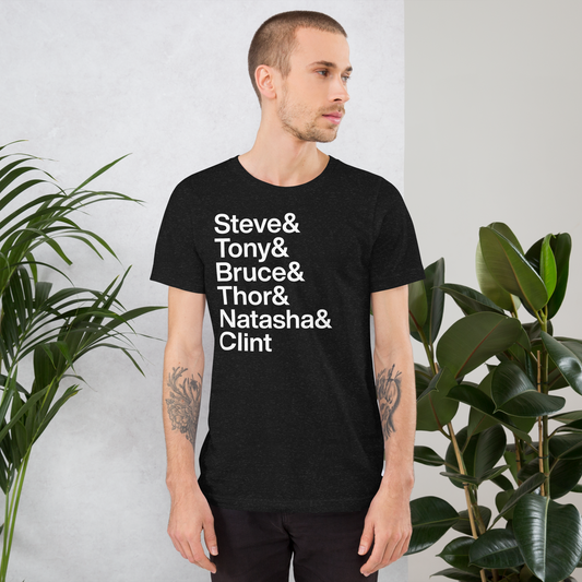 Young tattooed man wearing black t-shirt with white lettering reading Steve and Tony and Bruce and Thor and Natasha and Clint