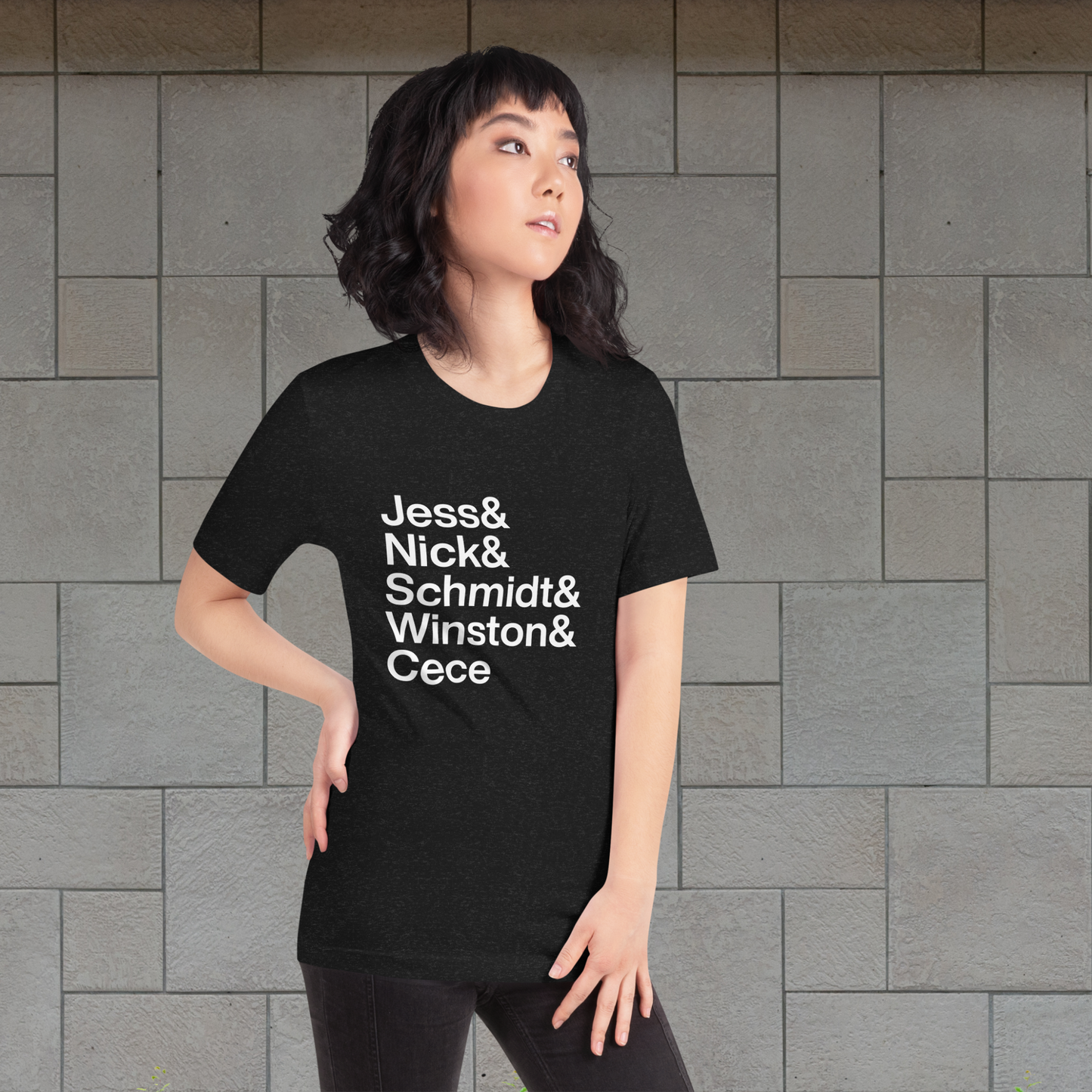 Young woman posing with a black t-shirt with white lettering reading Jess and Nick and Schmidt and Winston and Cece