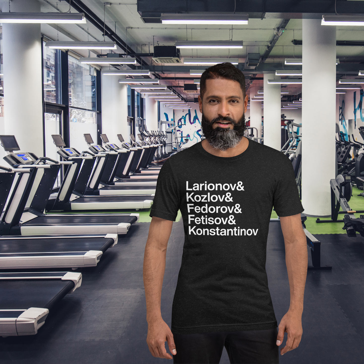 Guy with beard at gym wearing a black t-shirt with white lettering reading Larionov and Kozlov and Fedorov and Fetisov and Konstantinov
