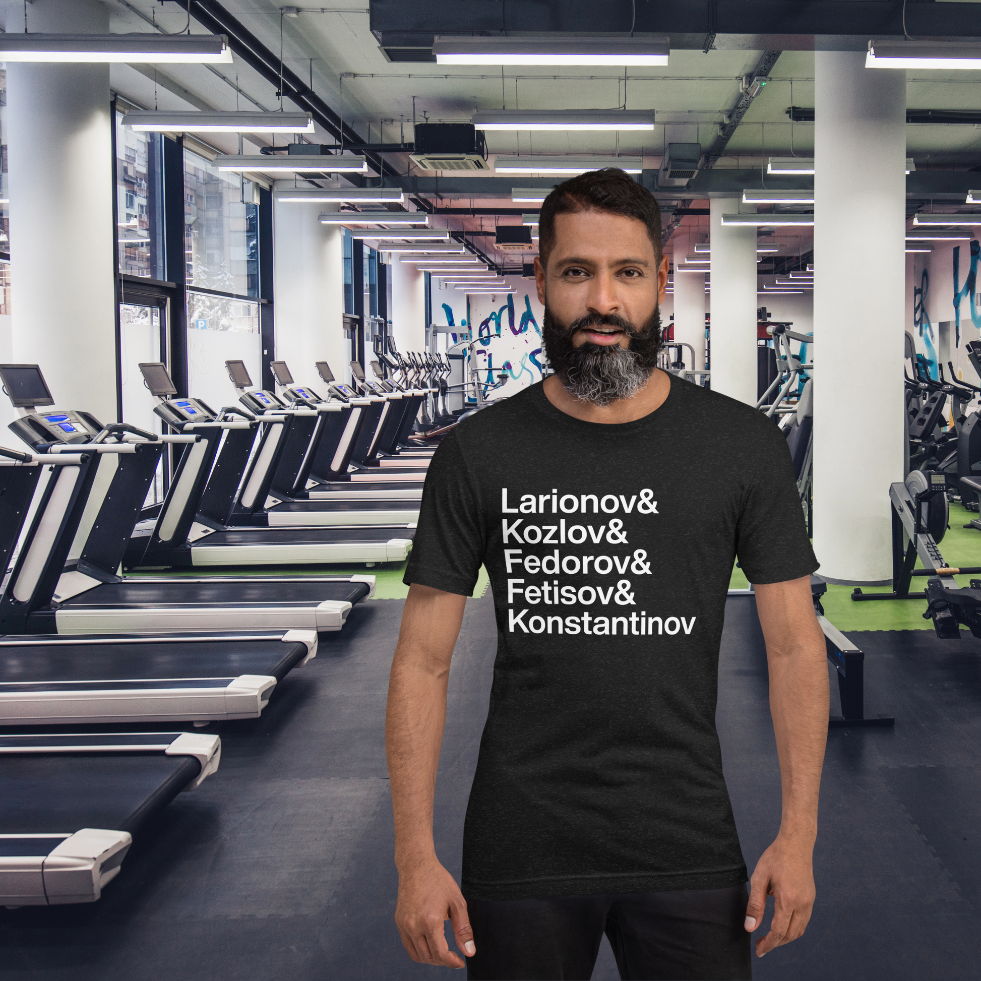 Guy with beard at gym wearing a black t-shirt with white lettering reading Larionov and Kozlov and Fedorov and Fetisov and Konstantinov