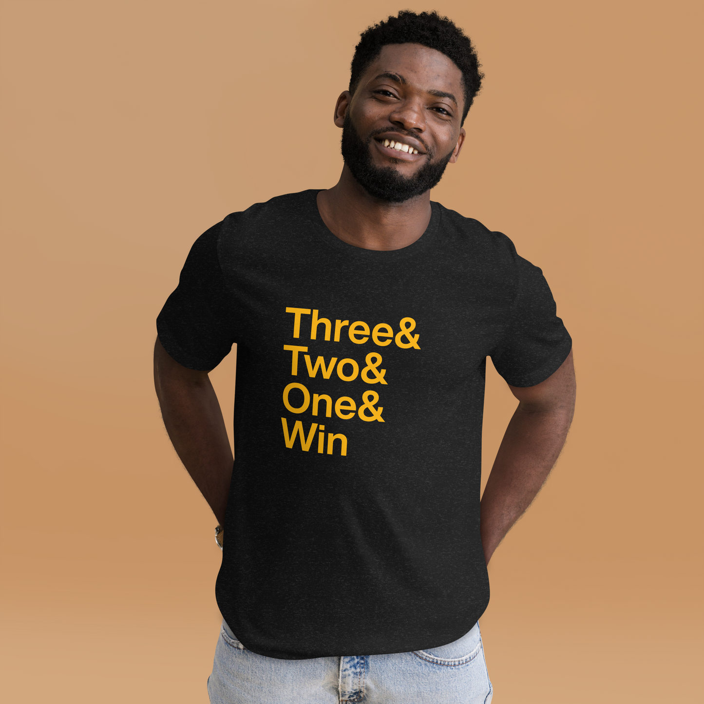 Man in black t-shirt with gold lettering reading Three and Two and One and Win