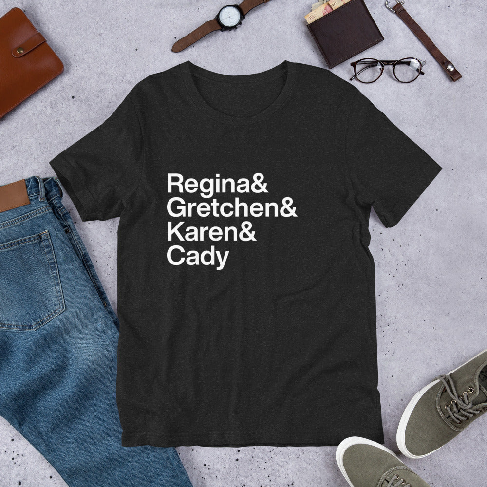 black t-shirt with white lettering reading Regina and Gretchen and Karen and Cady on the ground amidst other apparel