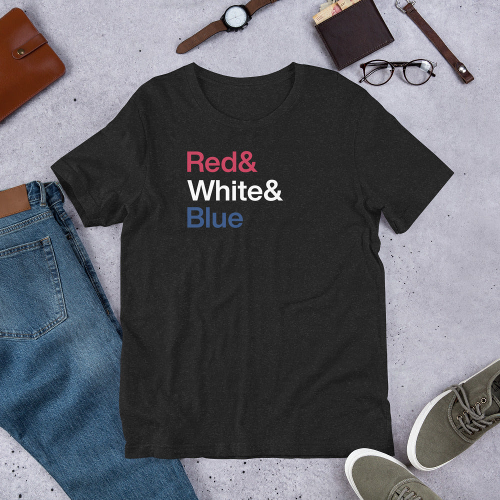 black t-shirt with letters reading Red and White and Blue on ground near other apparel