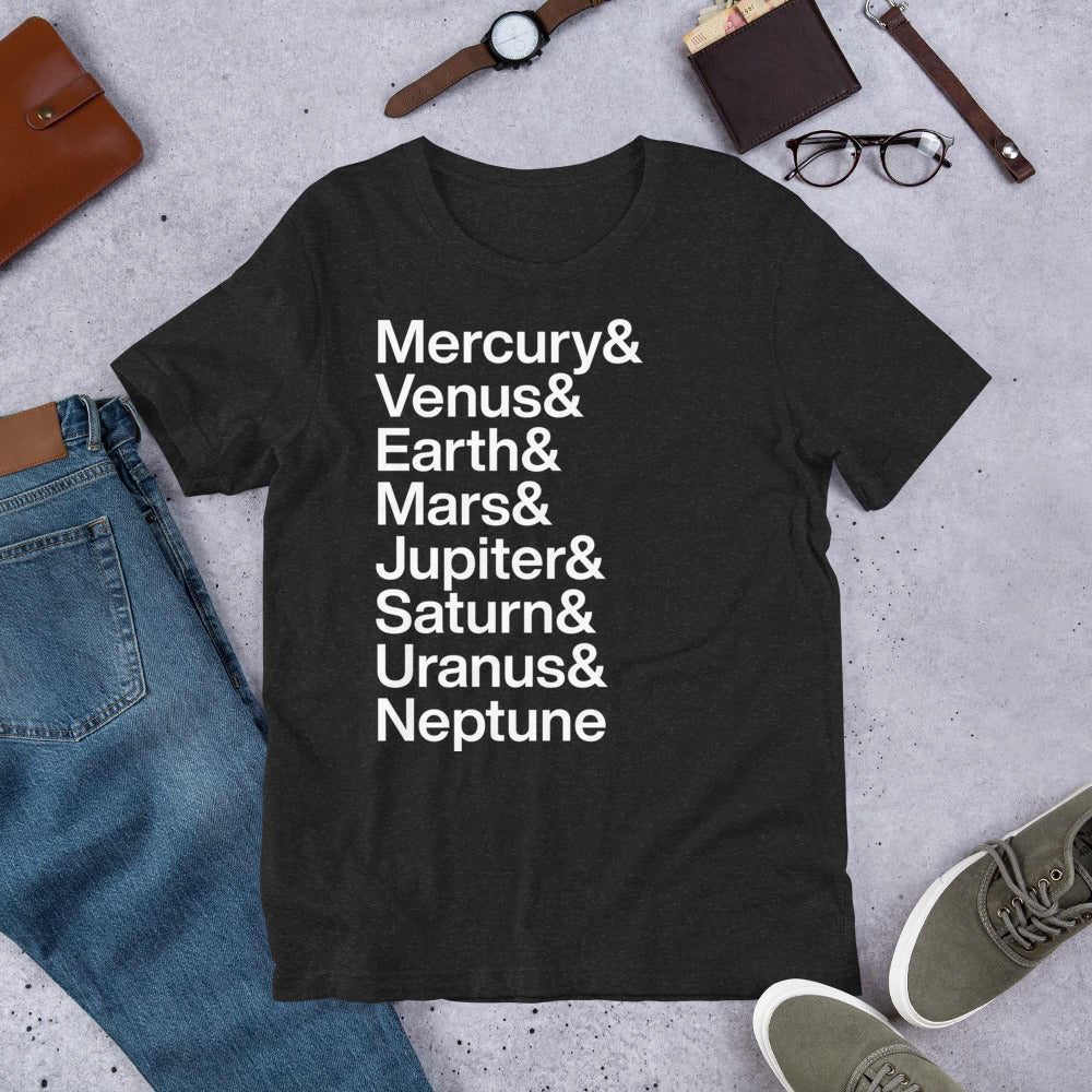 black t-shirt with white lettering depicting the names of the planets on the ground amidst other apparel