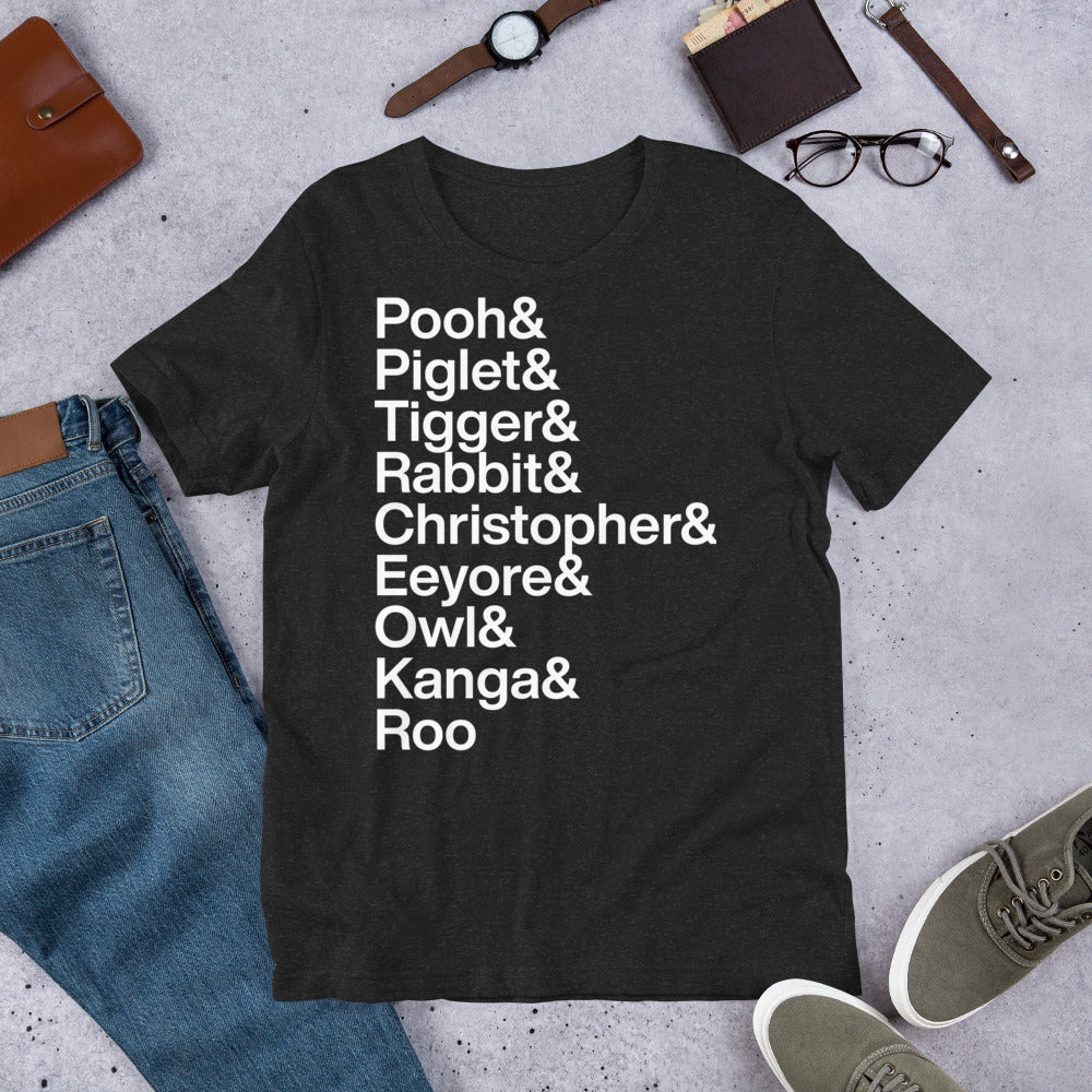 black t-shirt with white lettering reading Pooh and Piglet and Tigger and Rabbit and Christopher and Eeyore and Owl and Kanga and Roo on the ground with other apparel