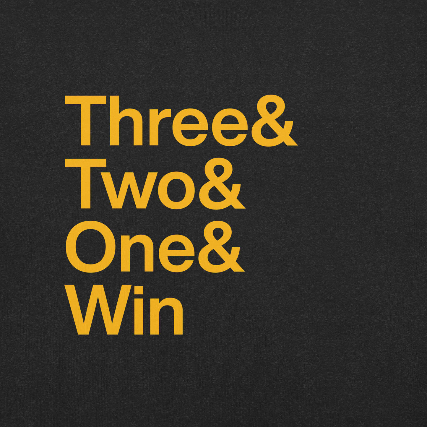 Close up of black t-shirt with gold lettering reading Three and Two and One and Win