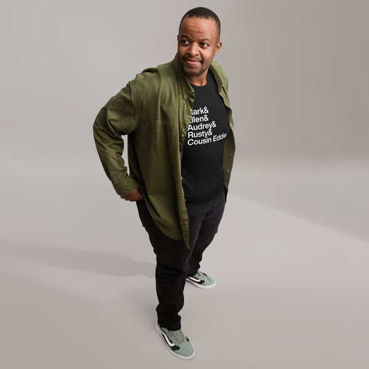 Man in jack with black t-shirt with white text reading Clark and Ellen and Audrey and Rusty and Cousin Eddie