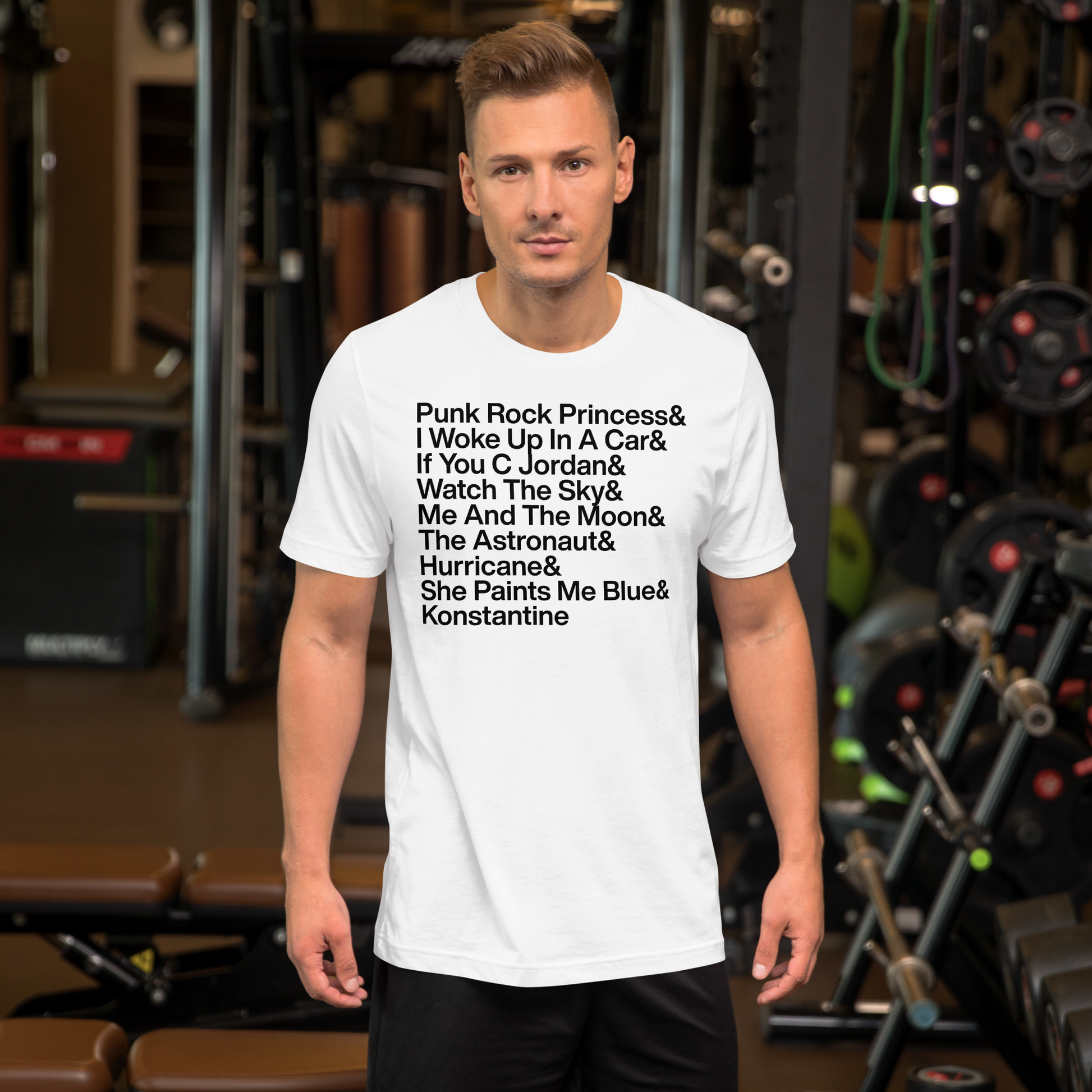 Man wearing a white t-shirt with text in a gym setting