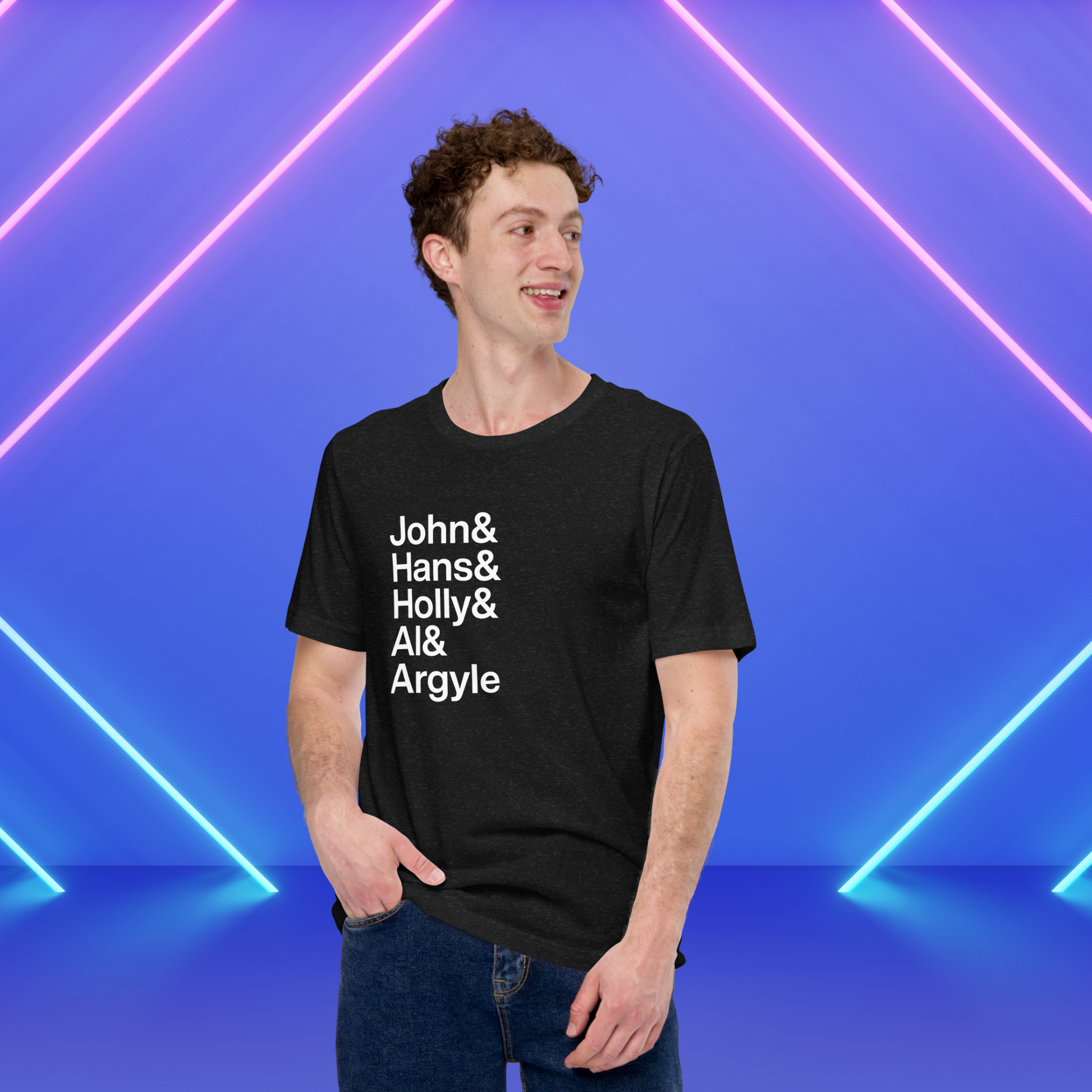 Young man wearing black t-shirt with white lettering depicting characters from Die Hard amidst neon lights